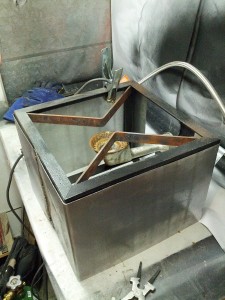 Shield fitted onto the burner frame